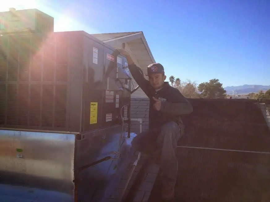 HVAC technician performing AC Tune-Up on a rooftop unit in West Hollywood